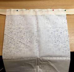 a piece of white fabric sitting on top of a wooden table