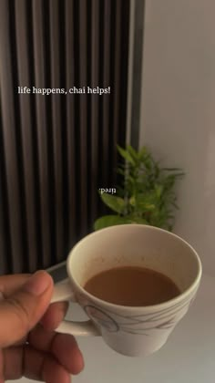 a person holding a coffee cup in their left hand with the words life happens, chai help