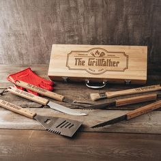 the grillahher barbecue tool set is sitting on a wooden table with utensils