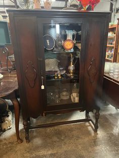 an antique china cabinet with glass doors