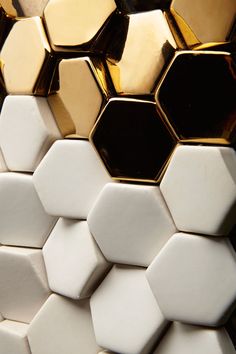 several white and gold hexagonal tiles stacked on top of each other