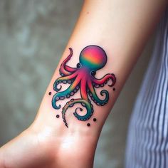 an octopus tattoo on the wrist is shown in this close up photo, it appears to be painted multicolored