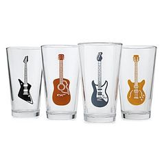 four glasses with guitars on them are lined up