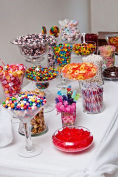 a table topped with lots of different types of candy and candies on top of it