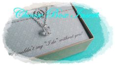 an open box with a necklace in it on top of a blue background and the words believe