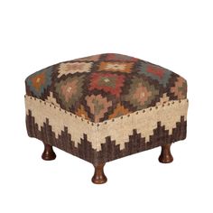 a foot stool made out of fabric with wooden legs and a colorful pattern on it