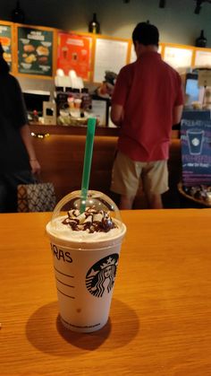 a starbucks drink sitting on top of a wooden table