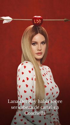 a woman with long blonde hair and red hearts on her head is holding an arrow above her head