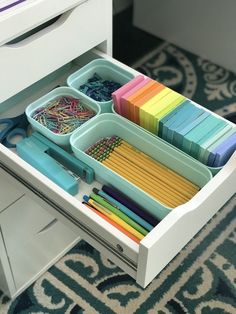 an organized drawer is shown with many different items in the drawers and on the floor