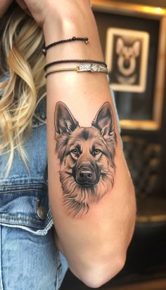 a woman with a dog tattoo on her arm