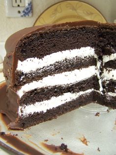 there is a chocolate cake with white frosting on the top and one slice missing