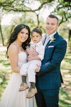 a man in a suit and tie holding a baby