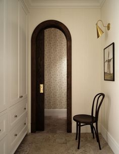 a chair sitting next to a doorway in a room