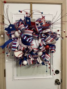 a baseball wreath with stars and stripes on the front door for an american flag theme