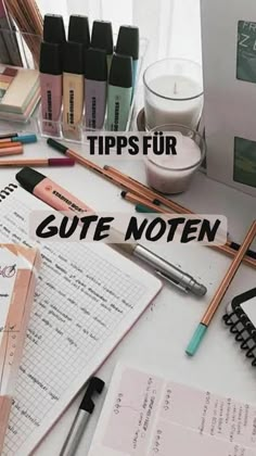 a desk with pens, notebooks and other items on it that says tips fur gute noten