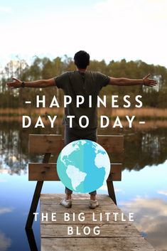 a man is standing on a dock with his arms outstretched and the words happiness day to day above him