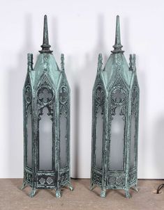 two green metal vases sitting next to each other