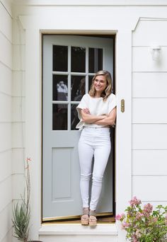 a woman standing in the doorway of a house