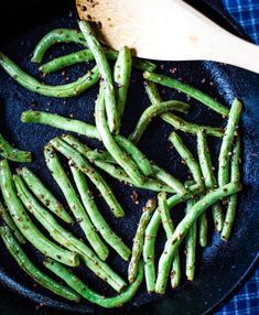 green beans are being cooked in a skillet