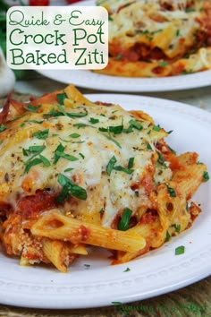 two white plates topped with cheesy crock pot baked zitti pasta