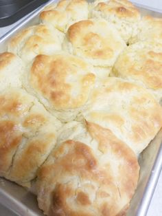 freshly baked biscuits sitting on top of a metal pan