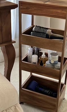 a wooden shelf filled with personal care items on top of a white carpeted floor