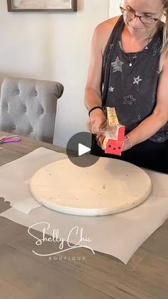 a woman is making pizza dough on the table