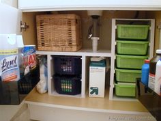 the shelves in the bathroom are organized with baskets and cleaning products, including toiletries