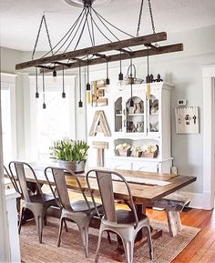 a dining room table with chairs and a chandelier hanging from it's ceiling