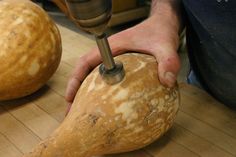 a person using a drill to cut up a large potato