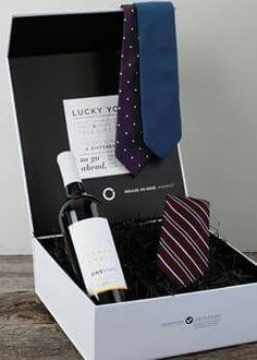 a wine bottle and tie in a white box