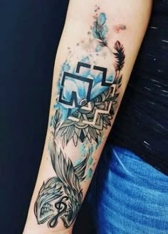 a woman with a tattoo on her arm and the letter n is painted in blue