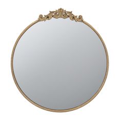 a round mirror with an ornate border around it