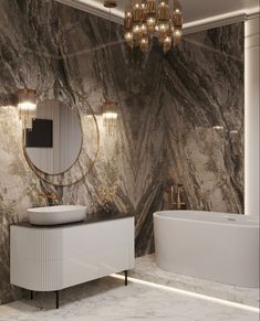 a bathroom with marble walls and flooring, a white bathtub next to a round mirror