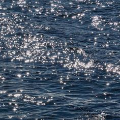 the sun shines brightly on the water as it reflects off the blue surface in this photo