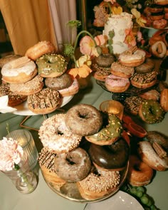 a table topped with lots of donuts covered in frosting