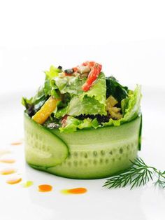 a salad in a cucumber with dressing on the side