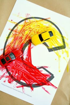 a child's drawing of a car in the shape of a circle with yellow and red paint