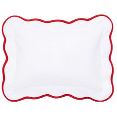 a white pillow with red trim on it