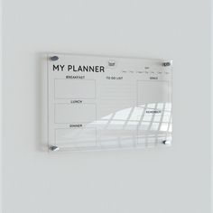 a white wall with a planner hanging on it's side and the words, my planner written in black