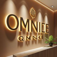 the omnie logo is lit up in front of a wall with a potted plant