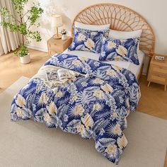 a bed with blue and yellow flowers on it