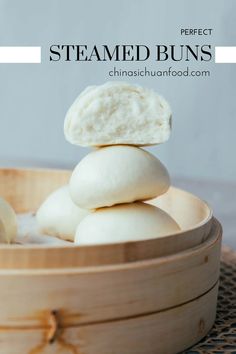 steamed buns stacked on top of each other in a wooden steamer basket with text overlay