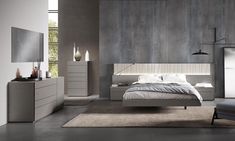 a modern bedroom with grey walls and furniture