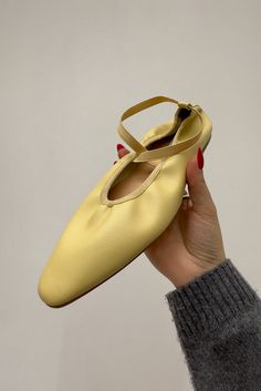 Pointed toe faux leather ballerina flats in a muted butter yellow color with criss cross elastic straps. Fit Runs half size small Composition This item is final sale Butter Yellow Aesthetic, Pointed Sandals, Bright Shoes, Muted Yellow, Pointy Heels, Yellow Fits, Sport Shoes Fashion, Butter Yellow, Fashion Sites