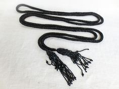 "French Antique Jet Black Corded Bead Belt, Victorian Belt, Black Glass Beads, Jet Black Tassels, Antique Belt, Extra Long Size Very small beads all hand sewn onto a round cord belt, black shiny facets, ending in jet black tubes around larger round tassels with multiple end strands. No loose beads, no apparent missing beads.  Measures: 116\" in from one end to the other end. It is very very long. To return to our shop: www.etsy.com/shop/artandsalvage Thanks for looking and have a great day!" Victorian Belt, Bead Belt, Cord Belt, Black Tube, Small Beads, Beaded Belt, French Antique, Belt Black, Suspender Belt