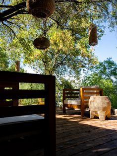 two wooden benches sitting on top of a wooden deck