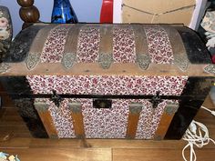 an old trunk sitting on top of a wooden floor