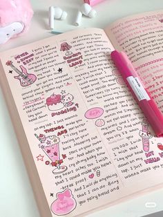 an open book with writing on it next to earbuds and a pink pen