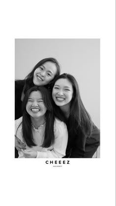 three girls are smiling and posing for the camera with their arms around each other in black and white